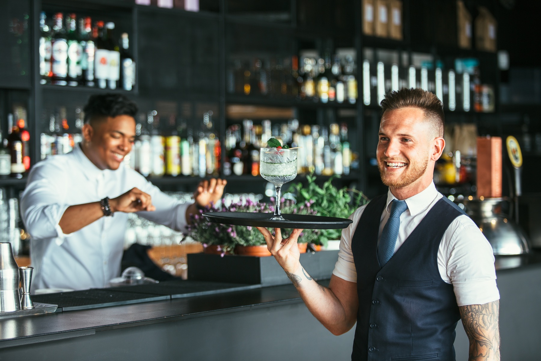 Bartenders running a cocktail to the floor