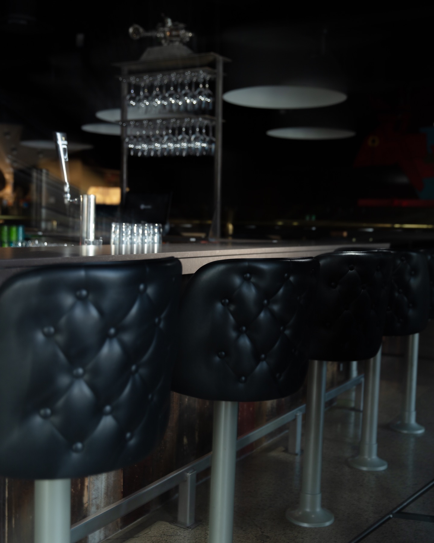 Bar seating and glassware in a Shifty restaurant